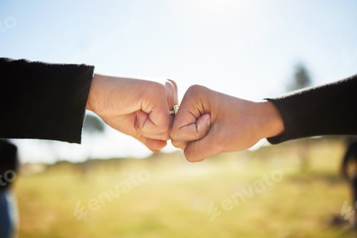 Preview: Guide us through this realm. Shot of two people fist bumping on another.