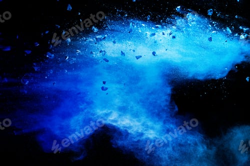Preview: Split debris of stone exploding with blue powder against black background.