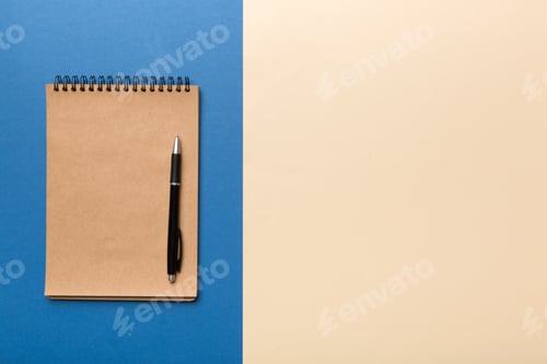 Preview: school brown notebook on a colored background, spiral craft notepad on a table Top view