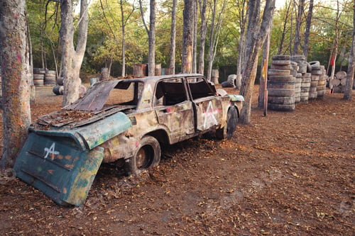 Preview: Old rusty and abandoned car at the paintball base
