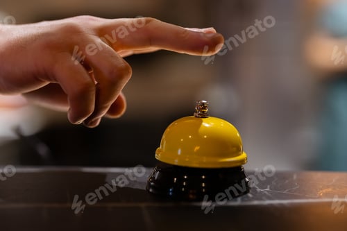 Preview: Finger rings the Service bell on blurred background
