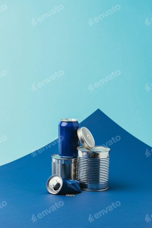Preview: close up view of arranged metal cans on blue background, recycle concept