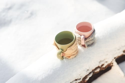 Preview: Two cups of tea on background of a winter landscape