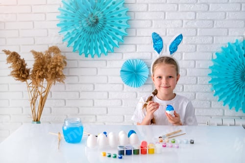 Preview: Girl Decorating Easter Eggs at Home on Table