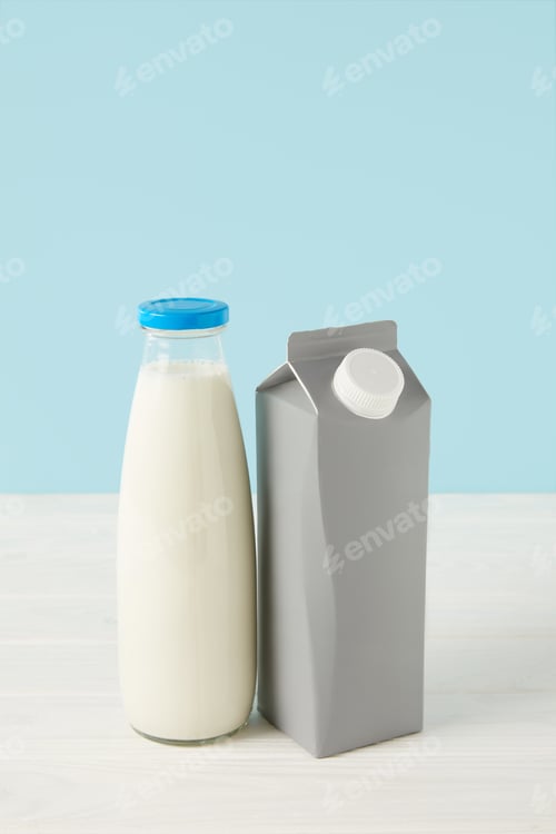 Preview: milk in bottle and blank carton package on blue background