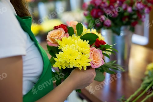 Preview: Workshop florist, making bouquets and flower arrangements. Woman collecting a bouquet of flowers
