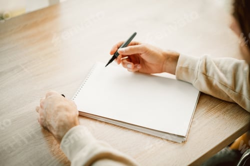 Preview: Man hands writing in a blank notebook