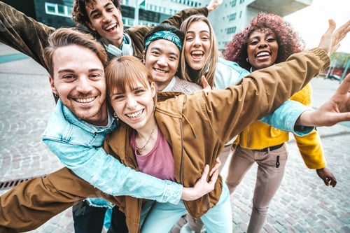 Preview: Multi ethnic young people smiling together at camera outside