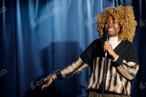 Preview: Young smiling female stand up comedian