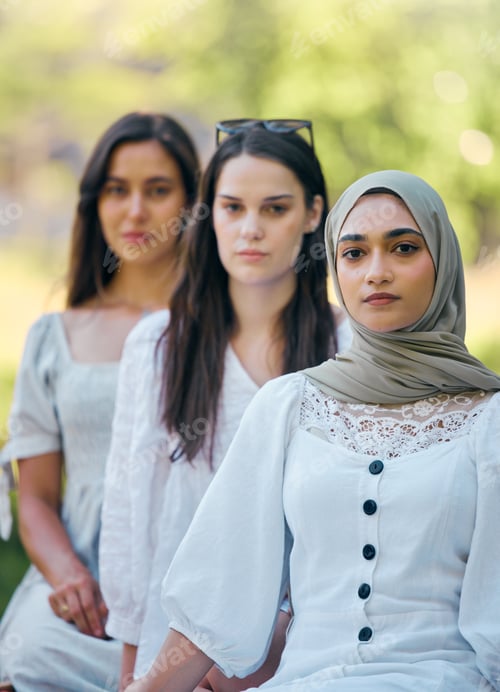 Preview: Muslim, islam and fashion with an islamic woman sitting outside with her friends in a line during t