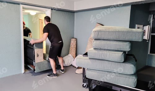 Preview: Millennial son gets help from friend who is a Furniture mover to load a sofa on truck downstairs.