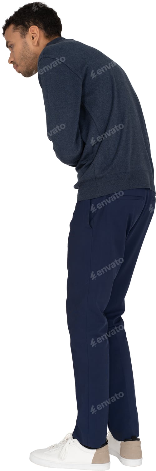 Vista previa: a man in a blue sweatshirt and trousers looking down at the ground