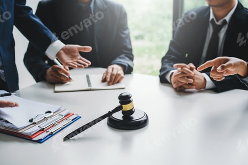 Preview: Businessmen and lawyers meeting and discuss lawsuit in the office.