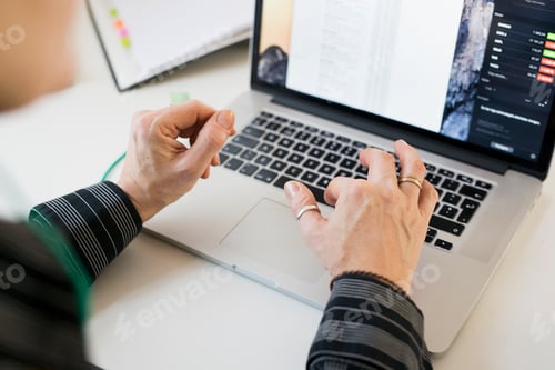 Preview: Cropped image of businesswoman's hands using laptop at desk in office
