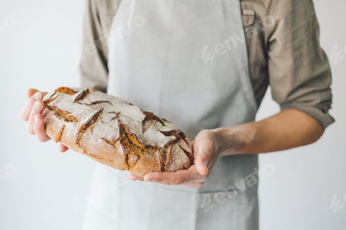 Preview: Baker or chef holding fresh made bread