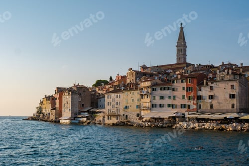 Preview: Charming coastal view of Rovinj, Croatia at sunset with historic buildings lining the waterfront