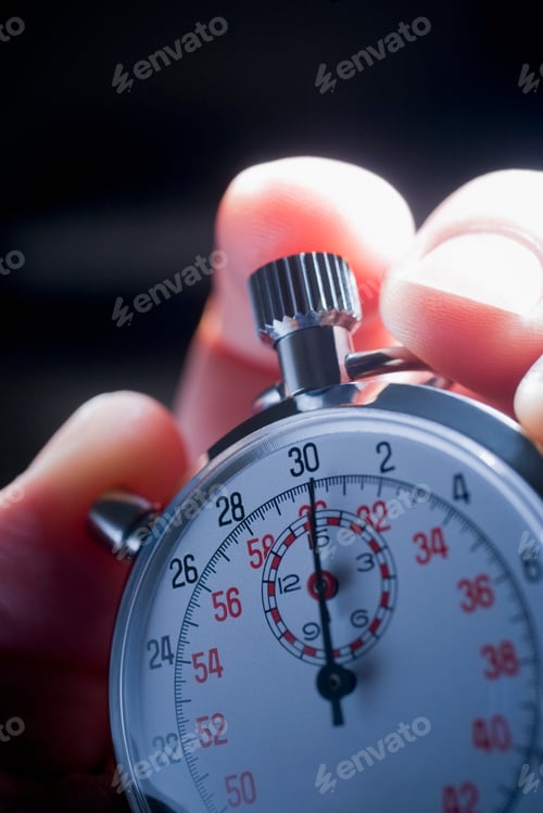 Preview: Cropped shot of hand holding silver stop watch