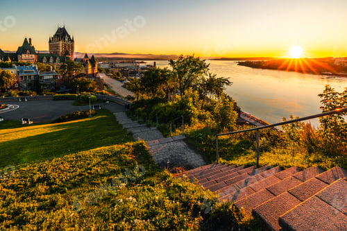 Preview: Beautiful view of the Chateau Frontenac surrounded by greenery in Quebec, Canada at sunrise