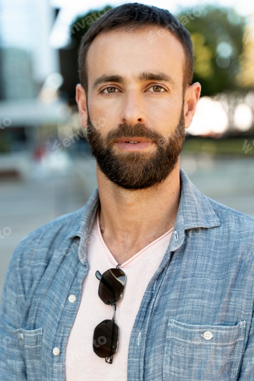 Preview: Pensive stylish hispanic man looking at camera on the street