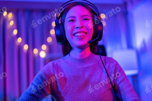 Preview: At home game player wearing headset have fun play battle streaming online game