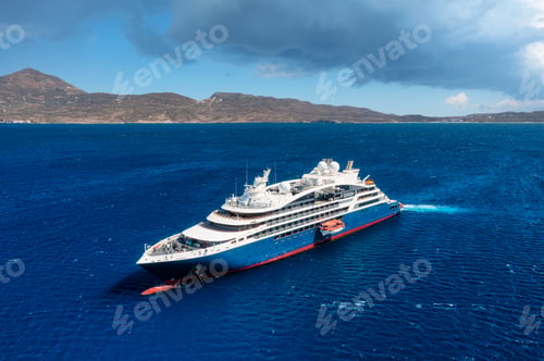 Preview: Cruise ship in port. Aerial view of the ship from drone. Blue clear water in the Mediterranean Sea.