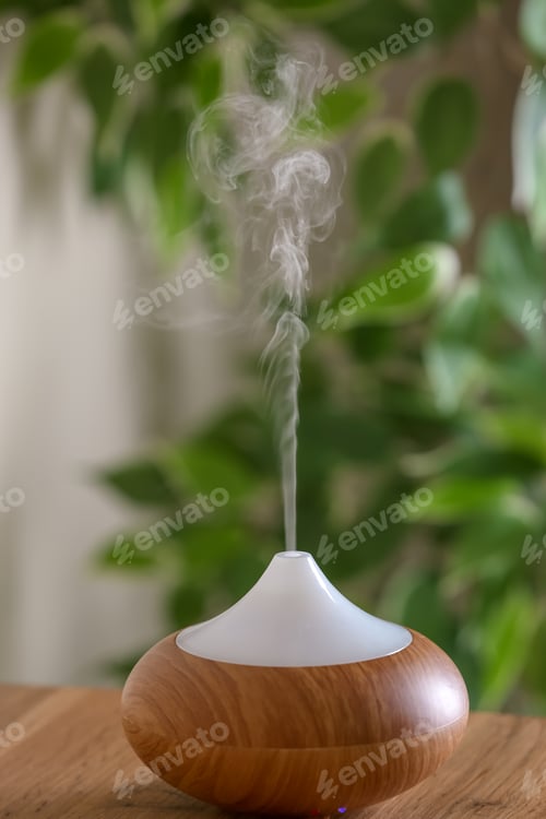 Preview: Aroma oil diffuser lamp on table against blurred background