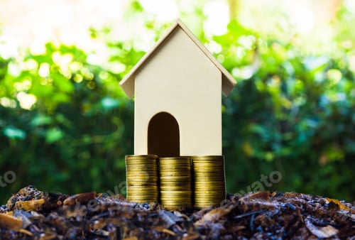 Preview: Property investment concepts. A small house model on stack of coins