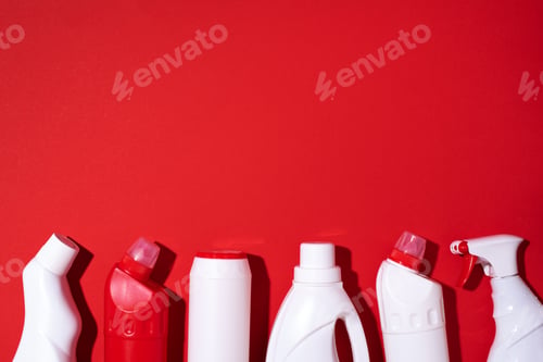 Preview: Cleaning products on red background. Copy space. Top view. Flat lay. Plastic waste. Detergent bottle