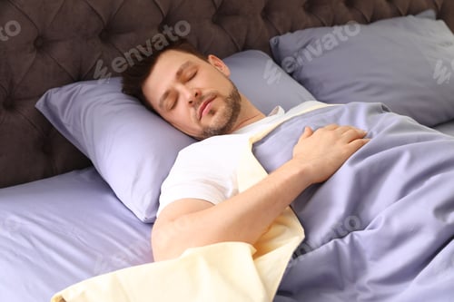 Preview: Handsome man sleeping on pillow at home. Bedtime