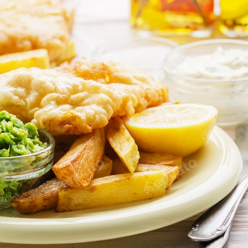 Preview: Traditional British street food fish and chips with tartar sauce and mushy peas on paper plate