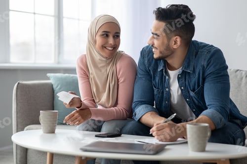 Preview: Happy muslim man and woman counting savings