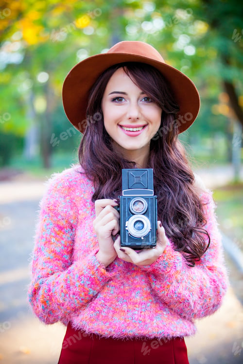 Preview: portrait of young woman with camera