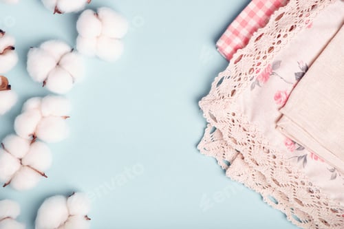 Preview: Cotton bolls and napkins made of cotton fabric on a blue background