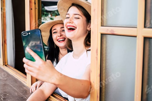 Preview: Two Young Women Taking a Selfie Indoors