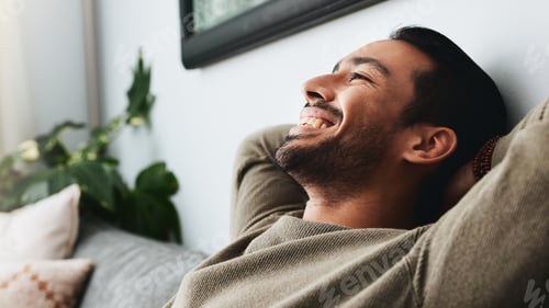 Preview: Relax, stretching and smile with man on sofa for peace, comfortable and resting. Happiness, cozy an