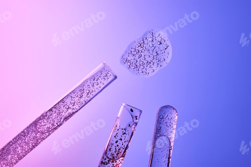 Preview: Textures of cosmetic serums in test tubes on a blue-purple background.