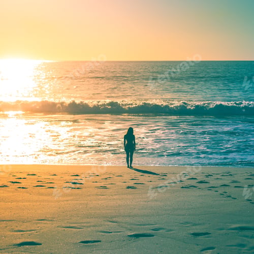 Preview: A woman staring out at the ocean on a warm, sunny, california afternoon