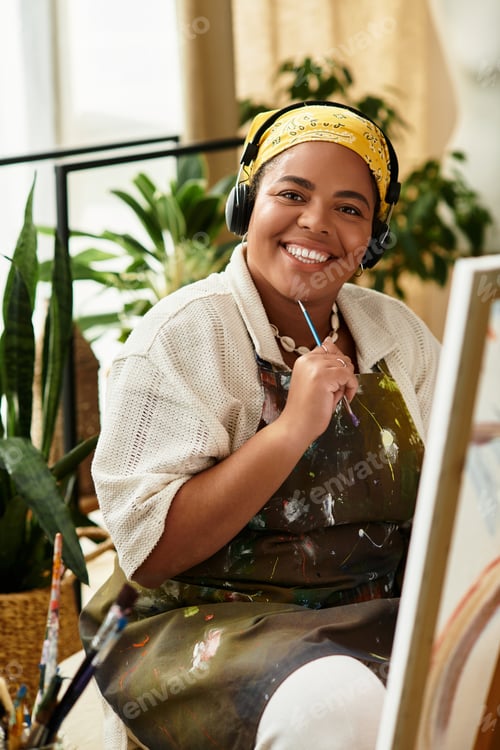 Preview: Beautiful woman smiles while painting in a vibrant crafting workshop filled with greenery