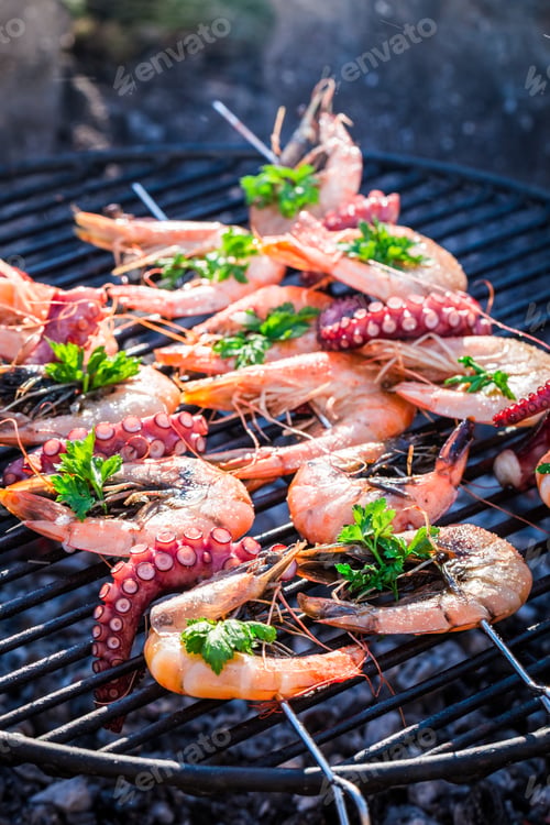 Preview: Fresh seafood with lemon and parsley on grill