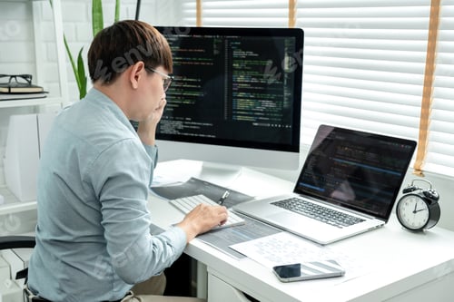 Preview: Male programmer is programming to develop program app and website of corporate while working t