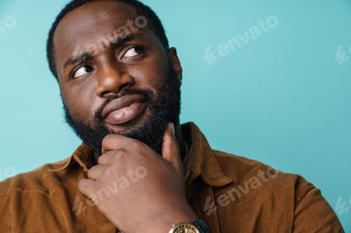 Preview: Serious african american man thinking and looking upward