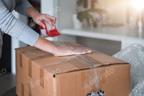 Preview: Woman is packing boxes getting ready for moving