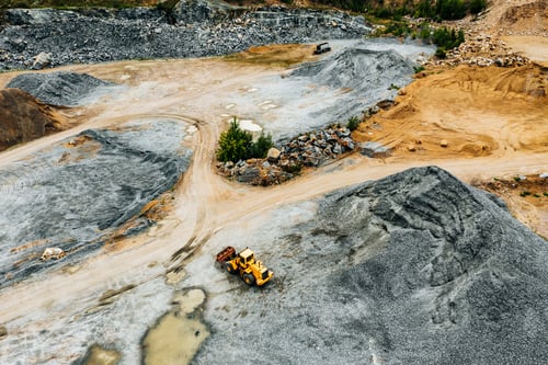 Preview: Aerial view of Truck excavator in open sand quarry rubble in Finland.