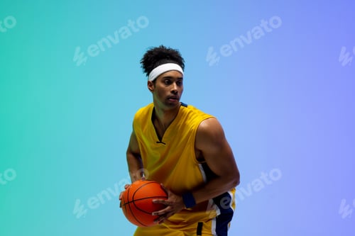 Preview: Image of biracial basketball player with basketball on green to blue background