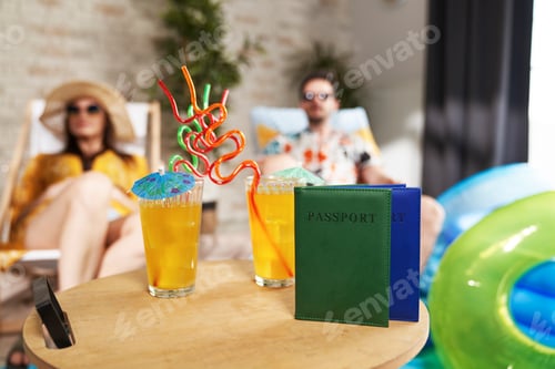 Preview: Close up of holiday drinks and passports on the table
