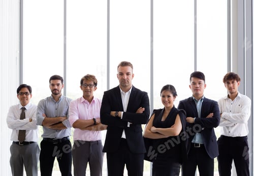 Preview: Group of business people with arms crossed in office