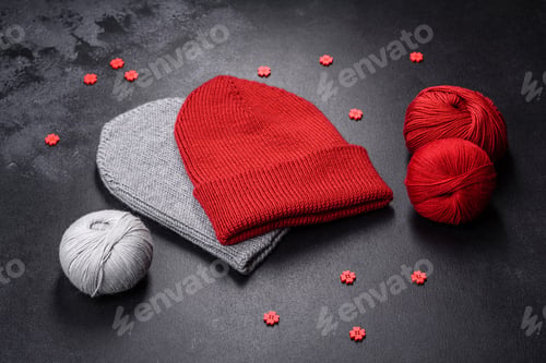 Preview: Red warm knitted women's hat on a concrete background