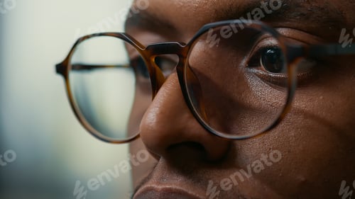 Preview: Closeup portrait of african american database developer with glasses working focused looking at