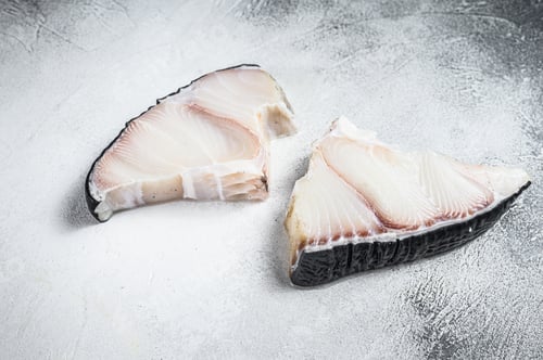 Preview: Raw Shark fish steaks on a kitchen table. White background. Top view