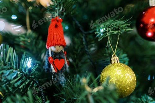 Preview: Figurine of a gnome in a hat with a heart in his hands hangs on a branch of a Christmas tree
